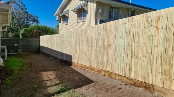 New timber boundary fence along a cleared backyard