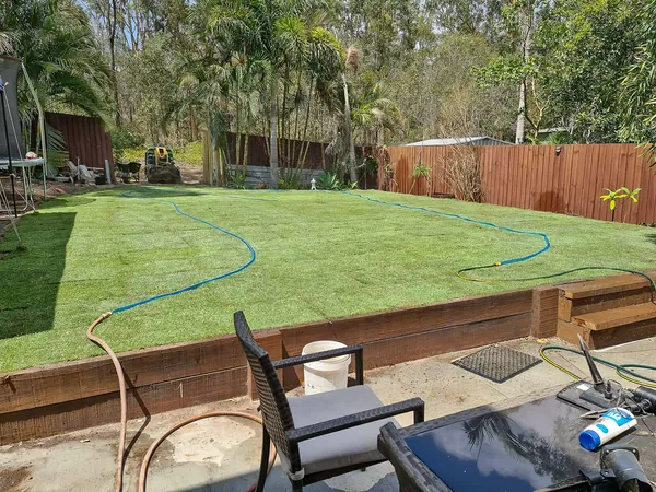 Finished yard with lawn, sleeper retaining and patio