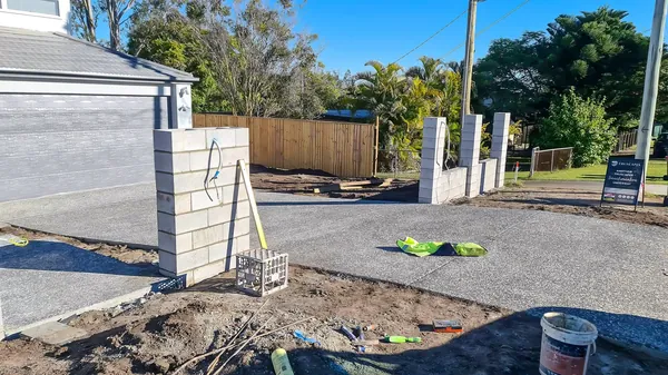 Block entry pillars and prepared driveway base